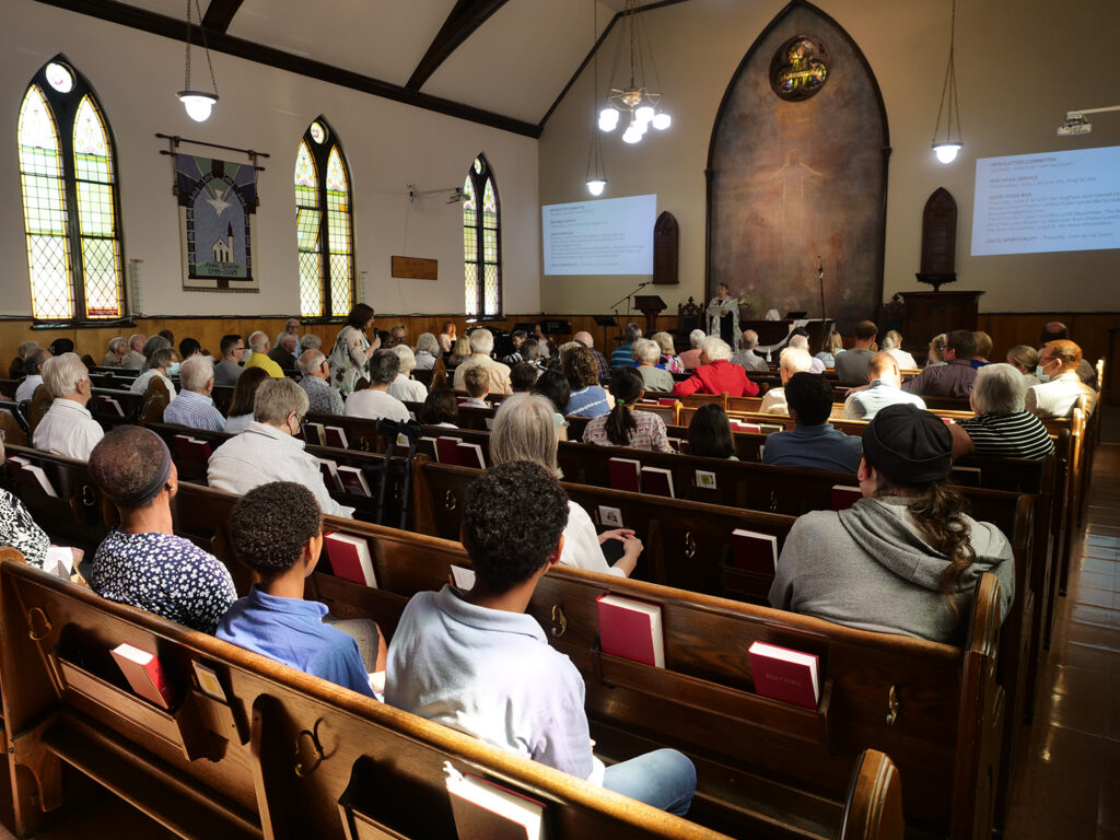 Sunday worship service with the congregation sitting in pews