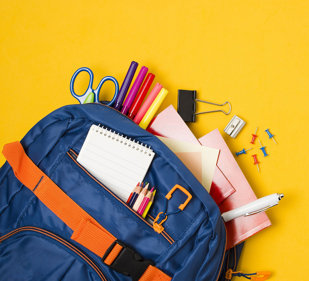 bright yellow background with a blue backpack full of pencils and school supplies
