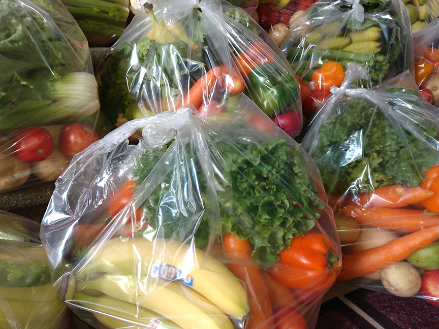 a plastic bag full of fruits and vegetables