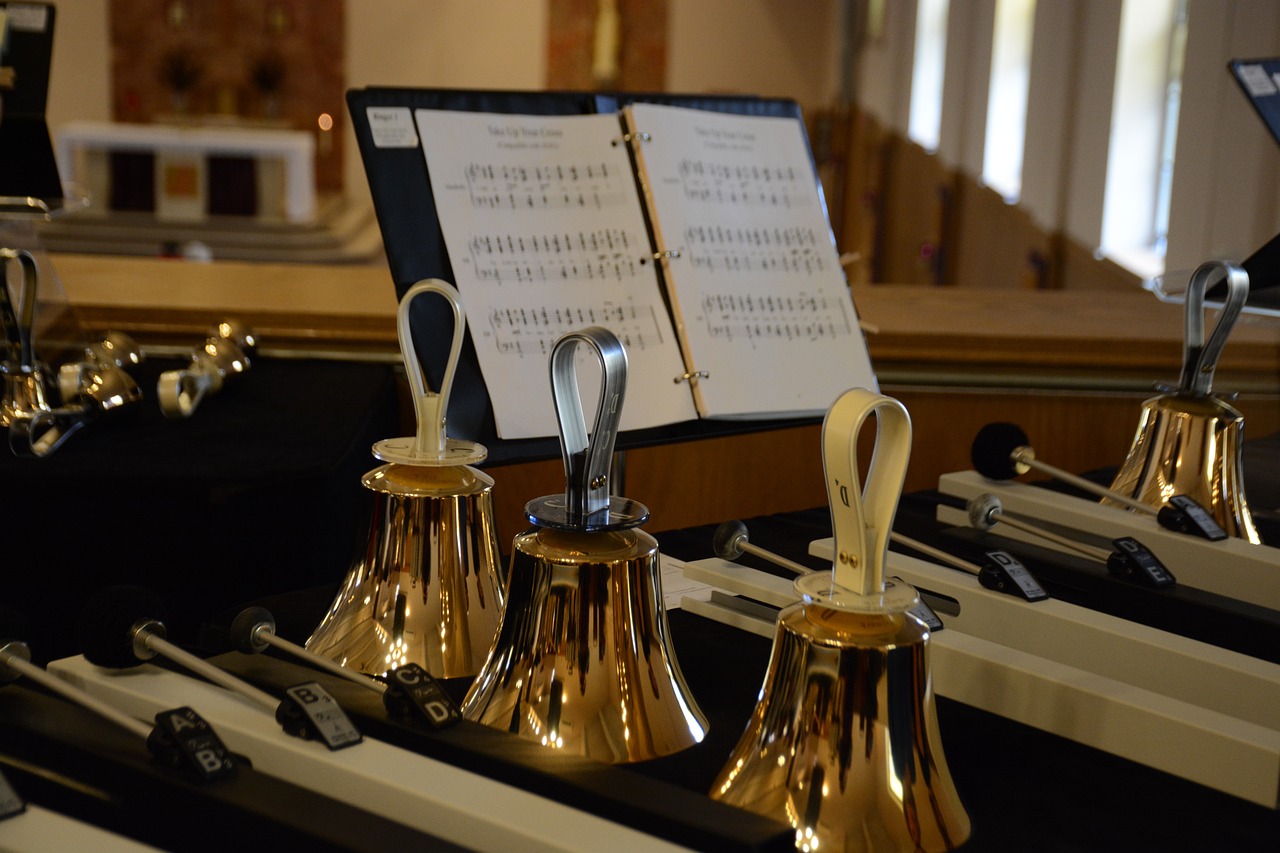 3 handbells resting on piano keys