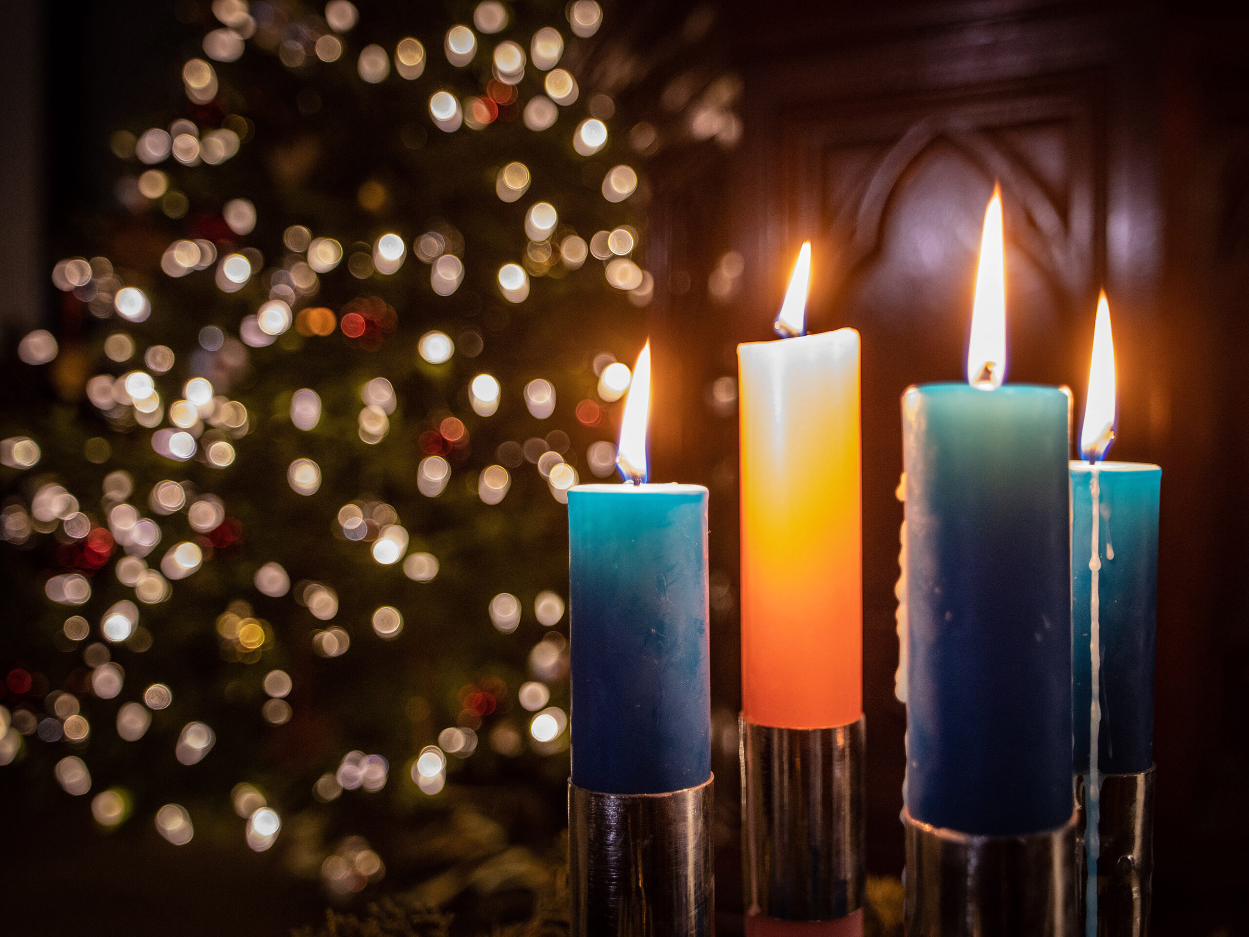 three lit candles on the alter