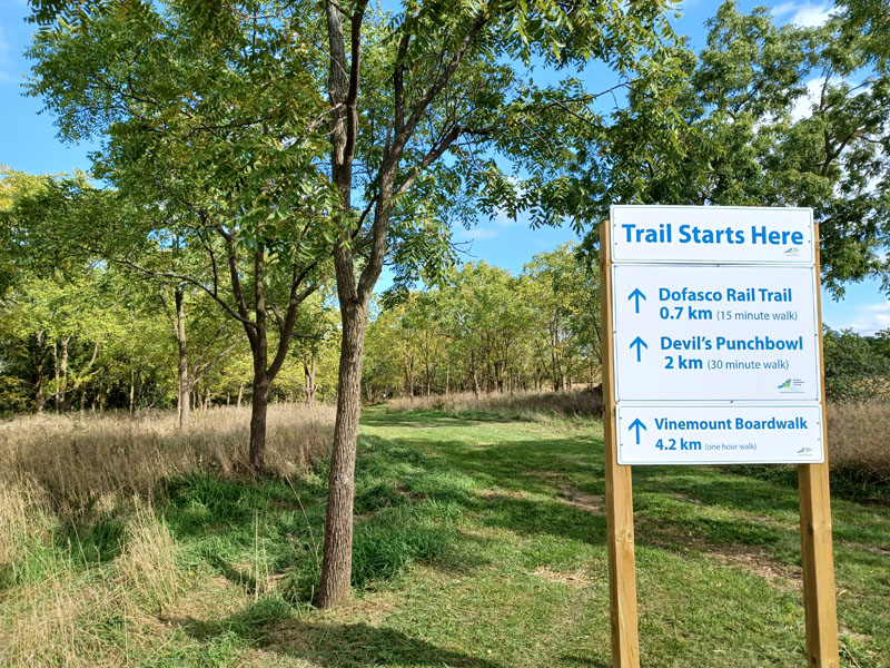 Saltfleet trail sign with many trees around