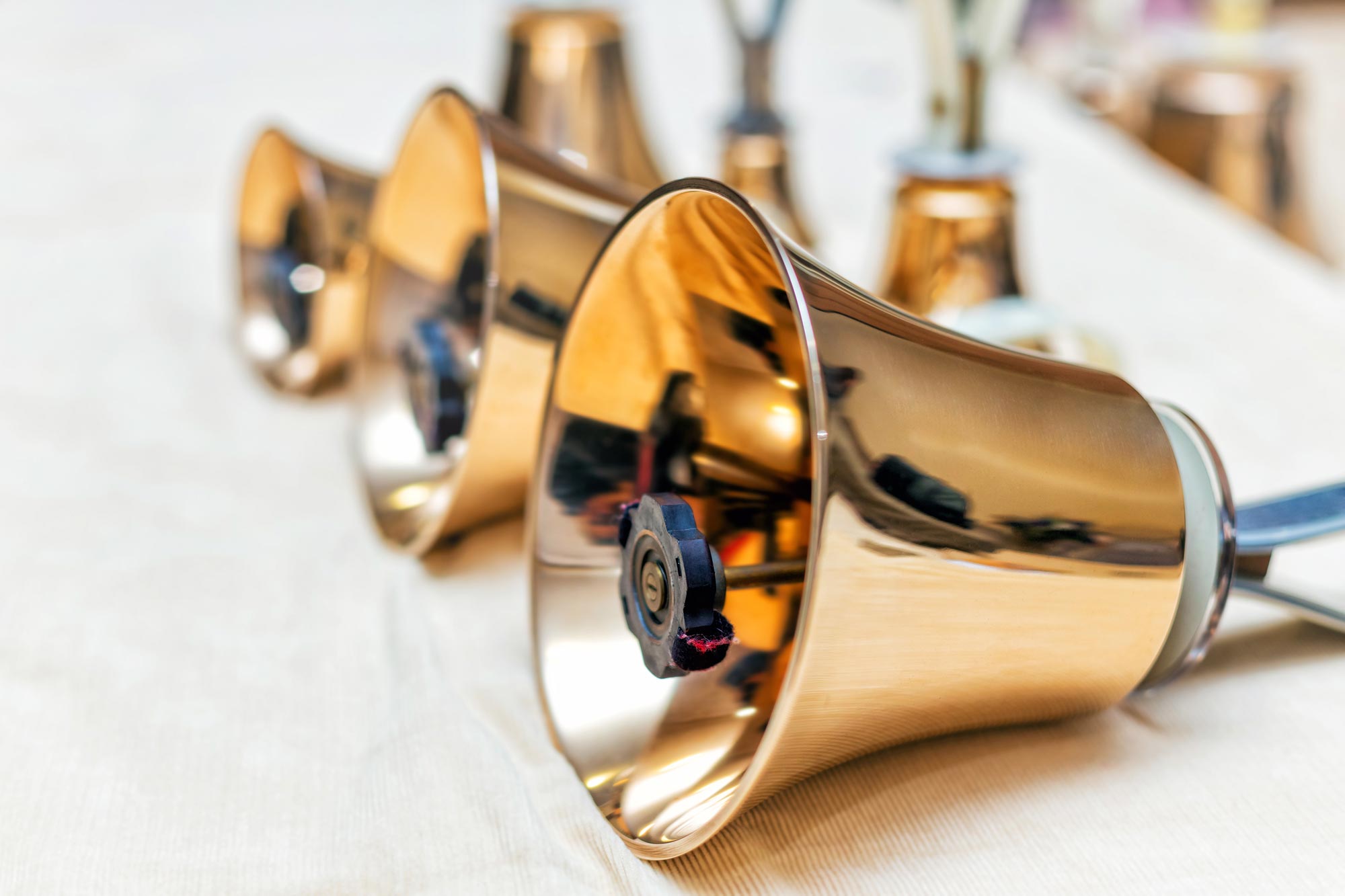 three gold handbells