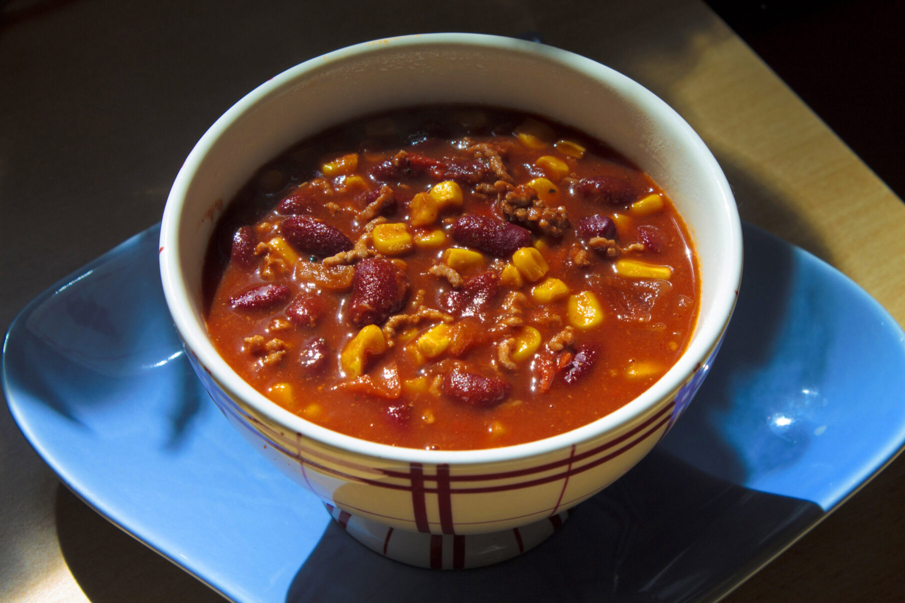 a bowl of chili with beef and beans